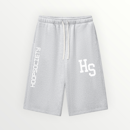 HoopSociety grey relaxed drawstring three-quarter sweatpants with white logo branding and wide-leg streetwear fit.