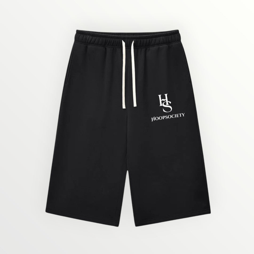 HoopSociety Beyond the Game black heavyweight fleece shorts with white drawstring and logo branding.