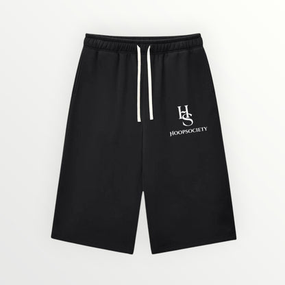 HoopSociety Beyond the Game black heavyweight fleece shorts with white drawstring and logo branding.